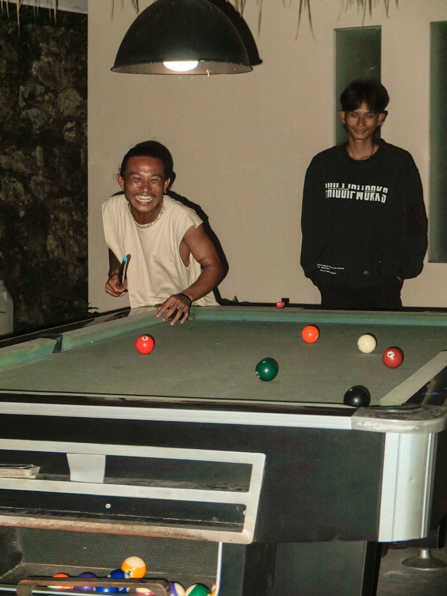 Guests playing night games at The Penida Project hostel bar